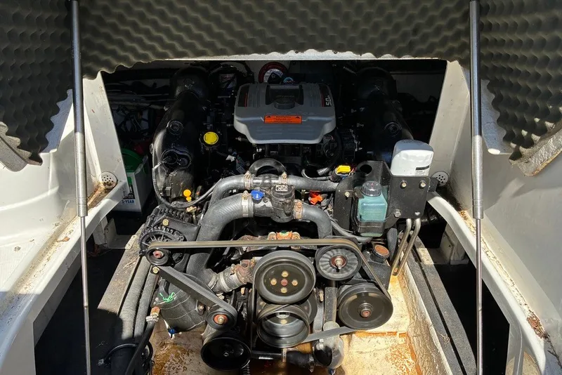 Slide: The Image of Engine compartment of a 2012 Crownline 236 SC boat, showcasing mechanical components. - 41