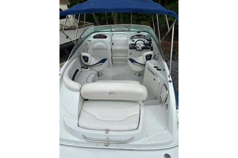 Slide: The Image of 2012 Crownline 236 SC boat interior with white seating and blue canopy. - 33
