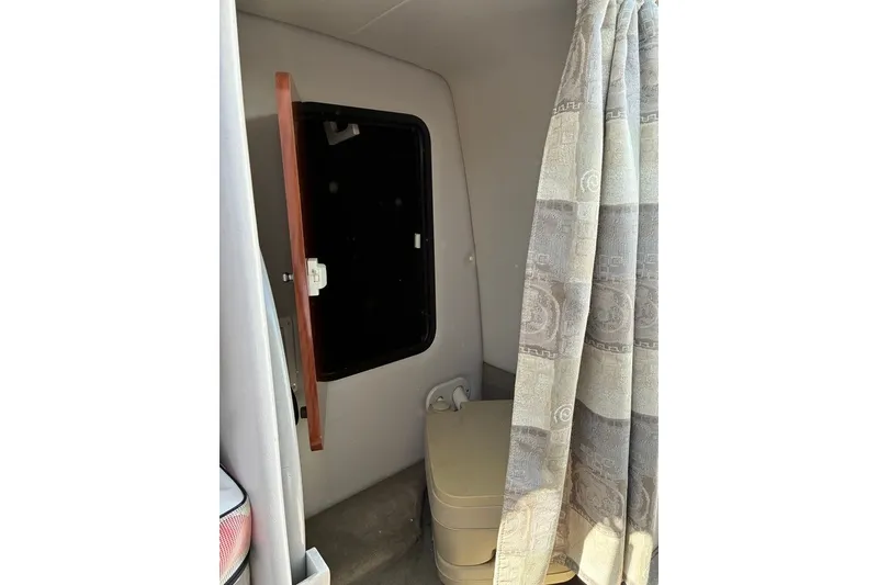 Slide: The Image of Interior cabin of 2012 Crownline 236 SC boat with curtain and window. - 44