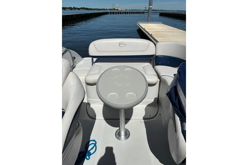 Slide: The Image of 2012 Crownline 236 SC boat interior with seating and table by the water. - 46