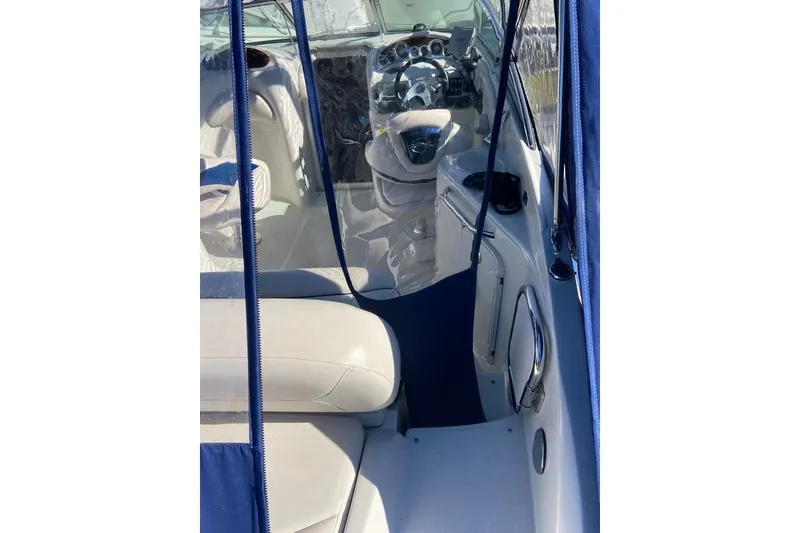 Slide: The Image of Interior view of 2012 Crownline 236 SC boat, featuring steering wheel and seating. - 15