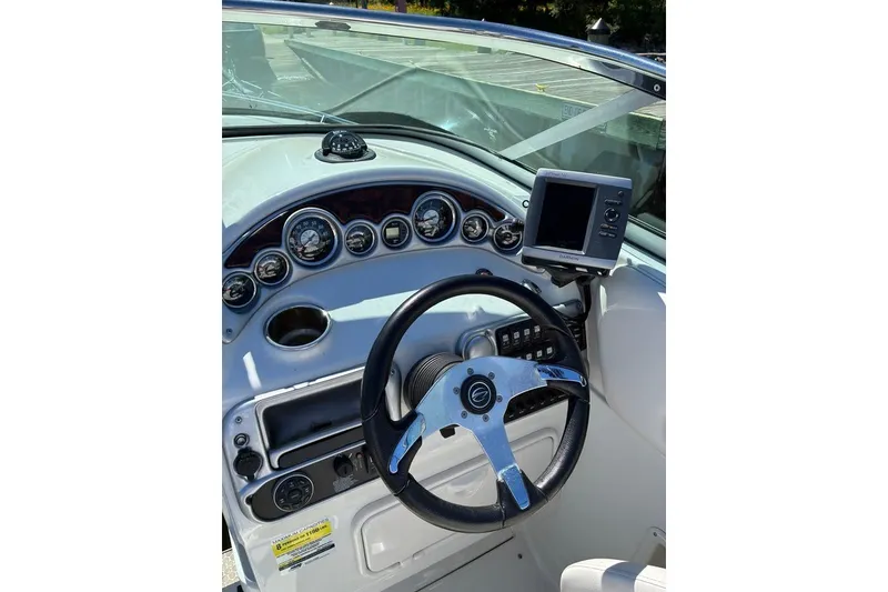 Slide: The Image of Steering console of 2012 Crownline 236 SC boat with gauges and navigation system. - 51