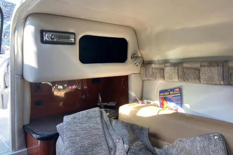 Slide: The Image of Interior cabin of a 2012 Crownline 236 SC boat with seating and storage. - 22