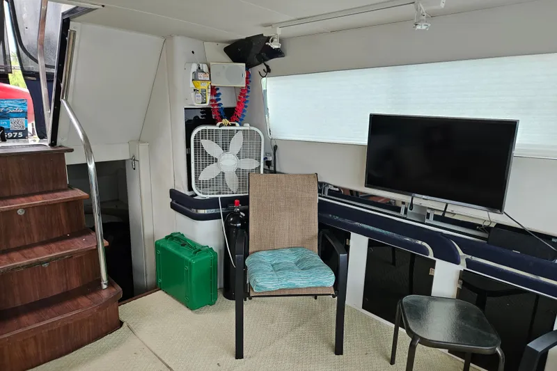 Slide: The Image of Interior of 1988 Wellcraft San Remo boat with seating, fan, and TV setup. - 30