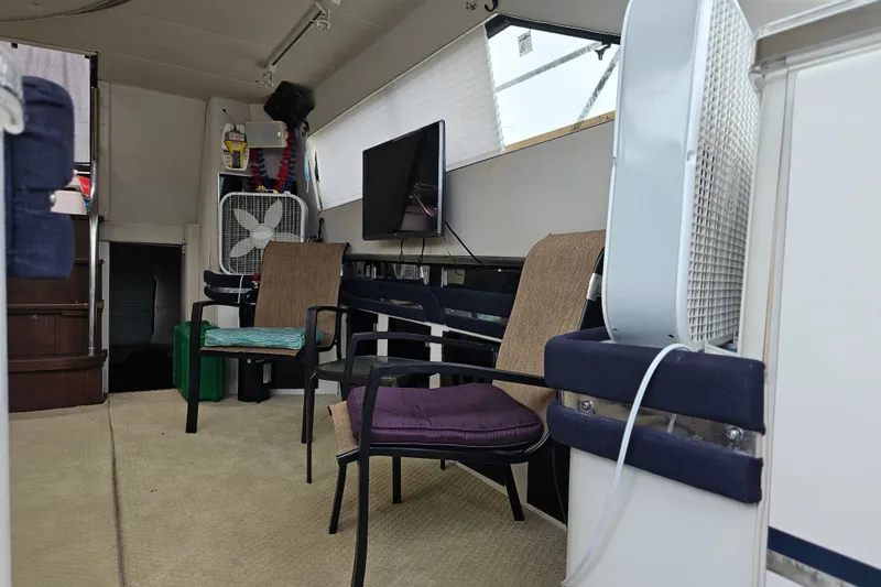 Slide: The Image of Interior of a 1988 Wellcraft San Remo boat with chairs, fan, and TV setup. - 27