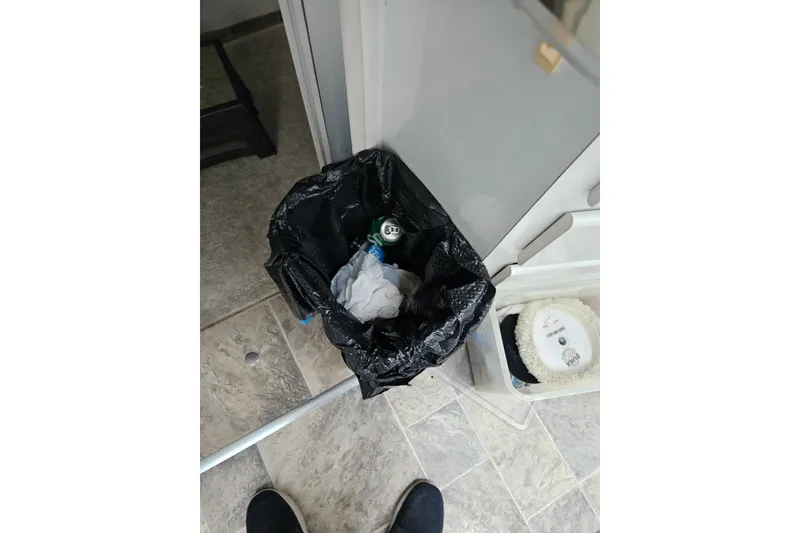 Slide: The Image of Trash bin with black liner on tiled floor, near cleaning supplies, aboard 1988 Wellcraft San Remo. - 20