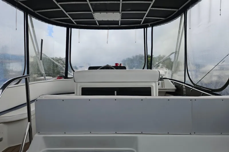 Slide: The Image of Interior view of a 1988 Wellcraft San Remo boat with clear windows and seating. - 17