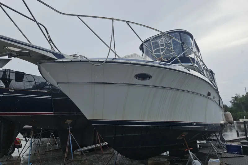 Slide: The Image of 1988 Wellcraft San Remo boat on stands, viewed from the front, with overcast sky. - 35