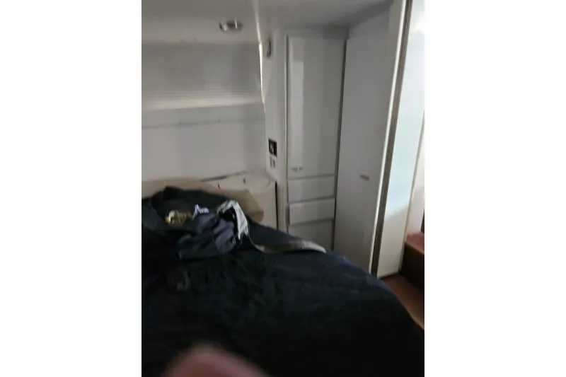 Slide: The Image of Interior cabin of 1988 Wellcraft San Remo yacht, featuring bed and storage area. - 31