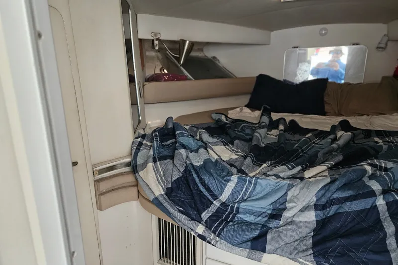 Slide: The Image of Interior cabin of 1988 Wellcraft San Remo boat with cozy bedding and pillows. - 22