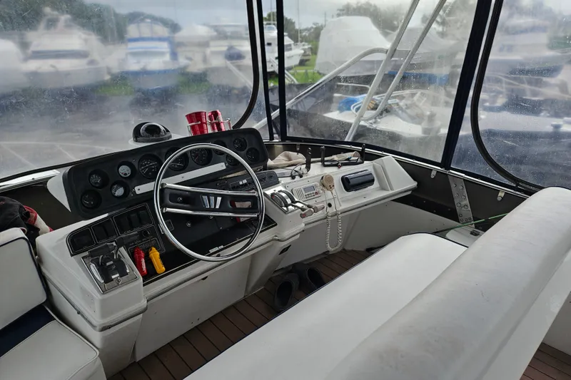 Slide: The Image of Interior cockpit of a 1988 Wellcraft San Remo boat, featuring steering wheel and control panel. - 14