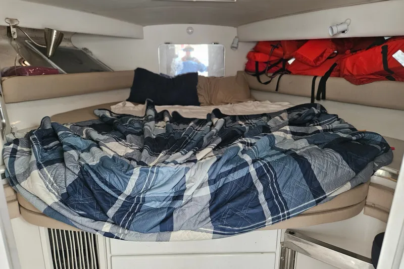 Slide: The Image of Interior cabin of 1988 Wellcraft San Remo boat with bed and life jackets. - 21