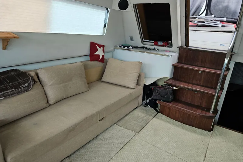Slide: The Image of Interior of 1988 Wellcraft San Remo yacht with beige sofa and wooden stairs. - 29