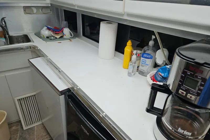 Slide: The Image of Kitchen area of a 1988 Wellcraft San Remo boat with coffee maker and condiments. - 24