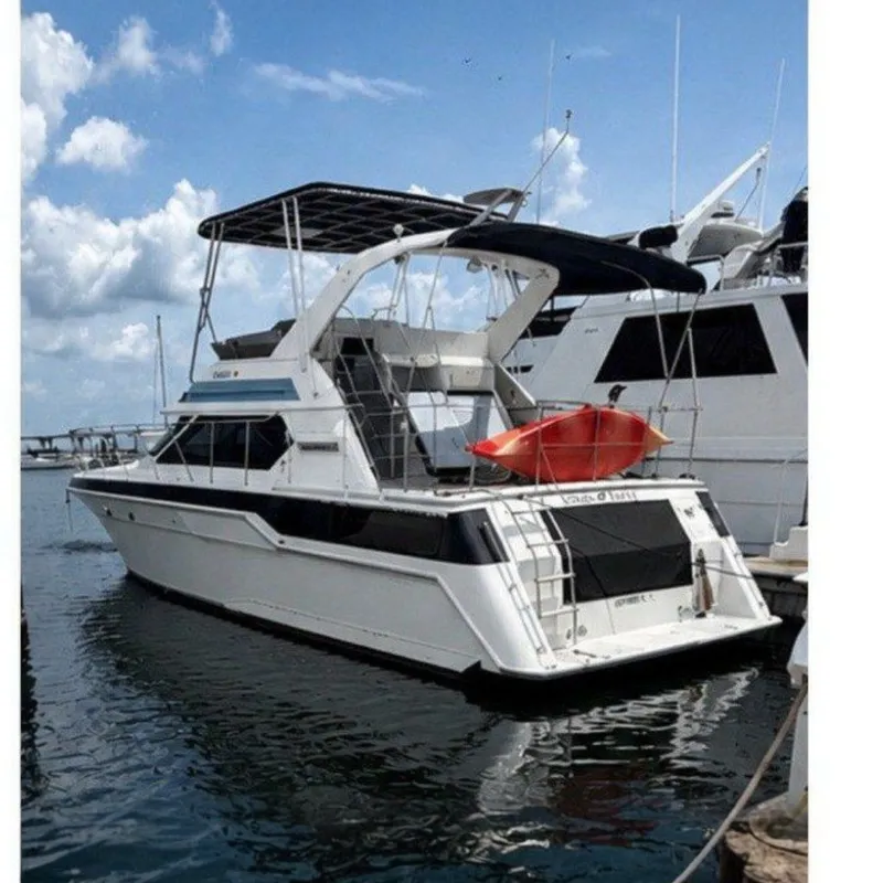 The Image of 1988 Wellcraft San Remo yacht docked at marina under blue sky. - 0