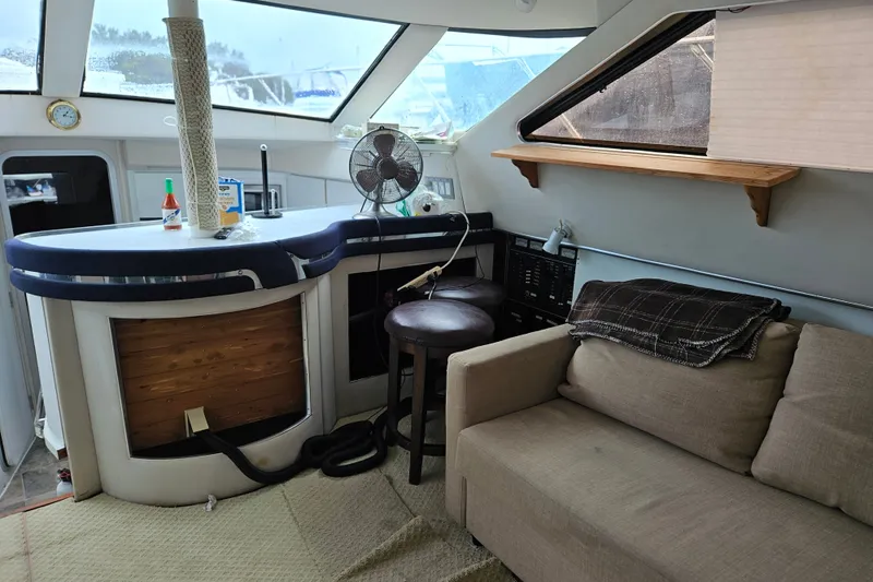 Slide: The Image of Interior of a 1988 Wellcraft San Remo yacht with a cozy seating area and bar. - 28