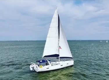 The Image of A 2017 Beneteau Oceanis 45 sailing on open water under a blue sky. - 0