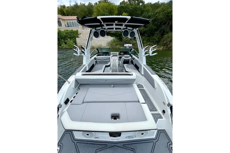 Slide: The Image of 2023 Cobalt R6 Surf boat with spacious seating and sleek design on a serene lake. - 13