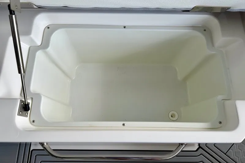 Slide: The Image of 2023 Cobalt R6 Surf boat storage compartment, open and empty, with hydraulic lift support. - 40
