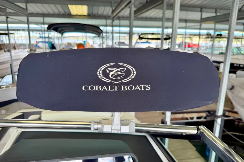 Slide: The Image of Cobalt R6 Surf 2023 boat headrest with logo in marina setting. - 32