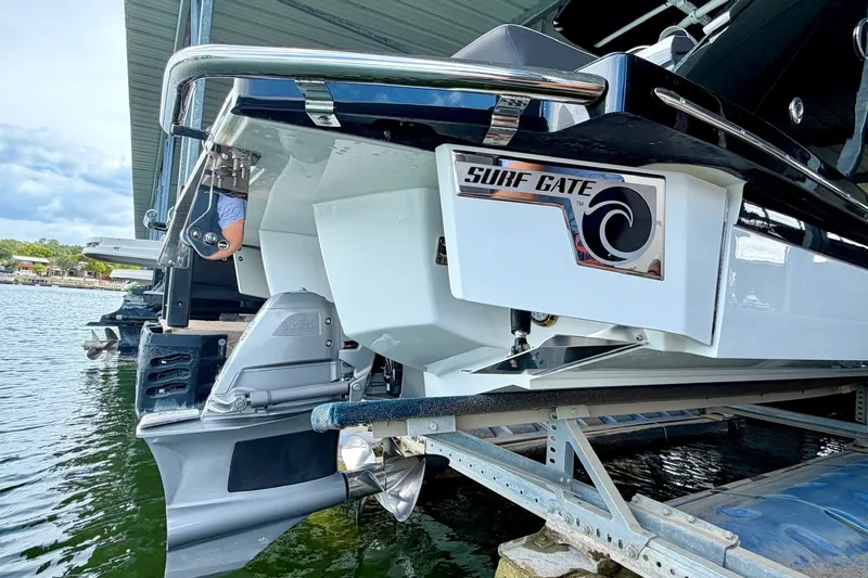 Slide: The Image of 2023 Cobalt R6 Surf boat with Surf Gate feature docked at marina. - 25