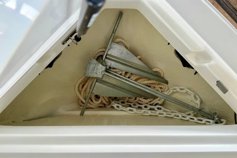 Slide: The Image of Anchor storage compartment in 2023 Cobalt R6 Surf boat with rope and chain. - 35
