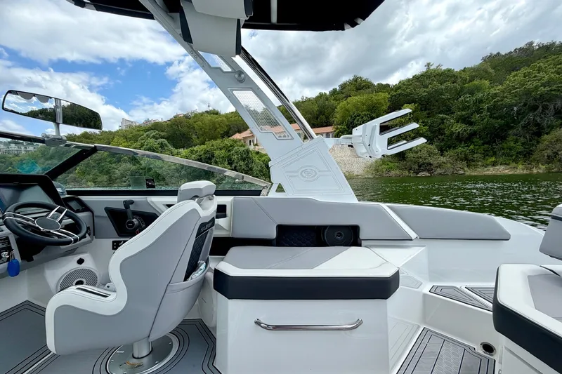 Slide: The Image of 2023 Cobalt R6 Surf boat interior with sleek design, steering wheel, and comfortable seating. - 16