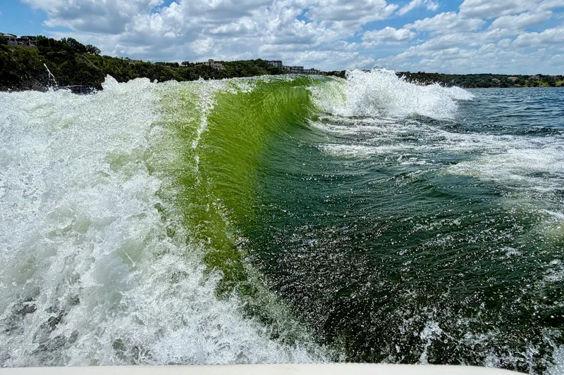 Slide: The Image of Waves created by 2023 Cobalt R6 Surf boat on a sunny day. - 8