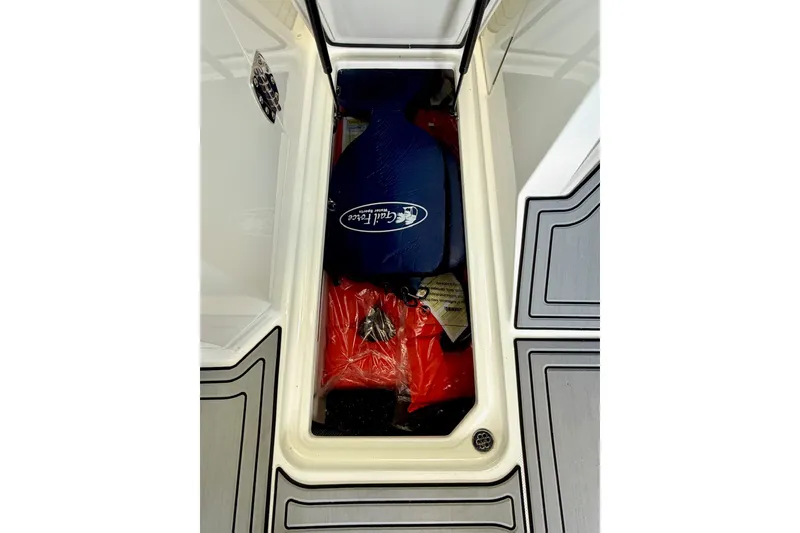 Slide: The Image of Storage compartment of 2023 Cobalt R6 Surf boat with life jackets and gear. - 38