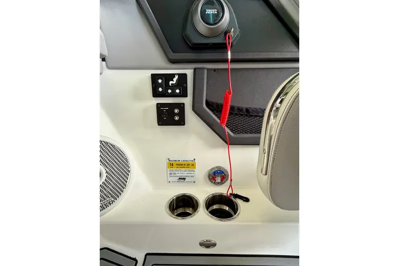 Slide: The Image of Control panel of 2023 Cobalt R6 Surf boat with switches and cup holders. - 42