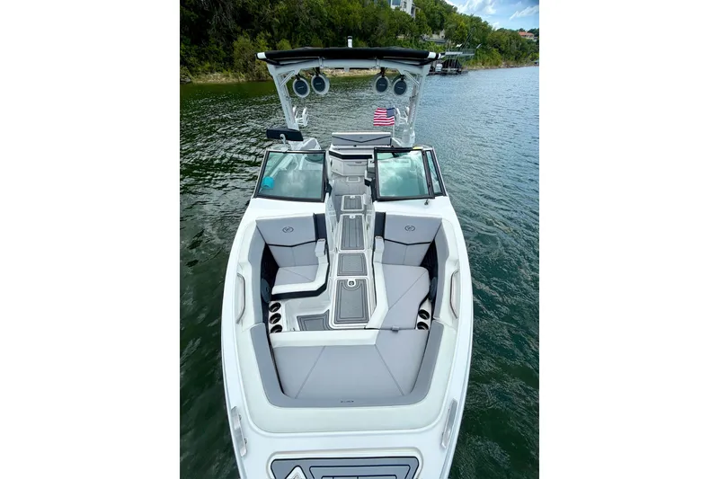 Slide: The Image of 2023 Cobalt R6 Surf boat on water, featuring sleek design and spacious seating. - 21