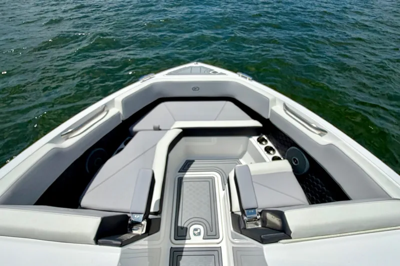 Slide: The Image of 2023 Cobalt R6 Surf boat interior with sleek seating and modern design on water. - 20