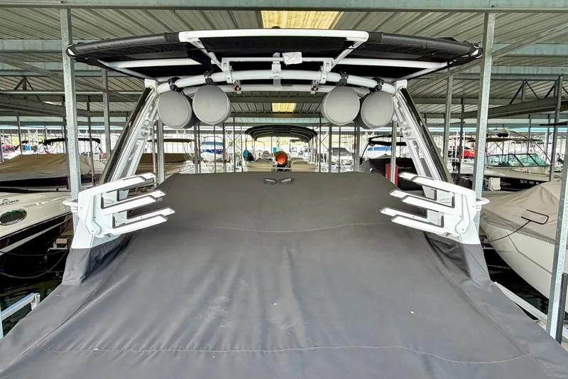 Slide: The Image of 2023 Cobalt R6 Surf boat covered in a marina, showcasing sleek design and modern features. - 30