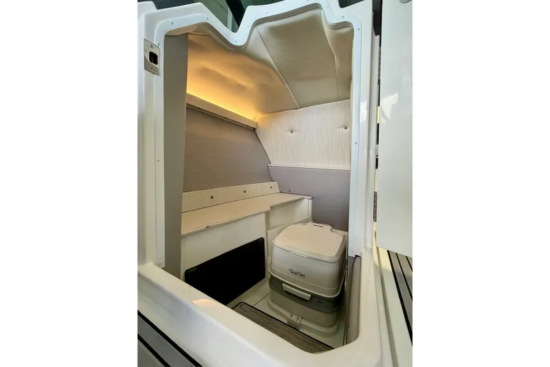 Slide: The Image of Interior cabin of 2023 Cobalt R6 Surf boat, featuring compact seating and modern design. - 31