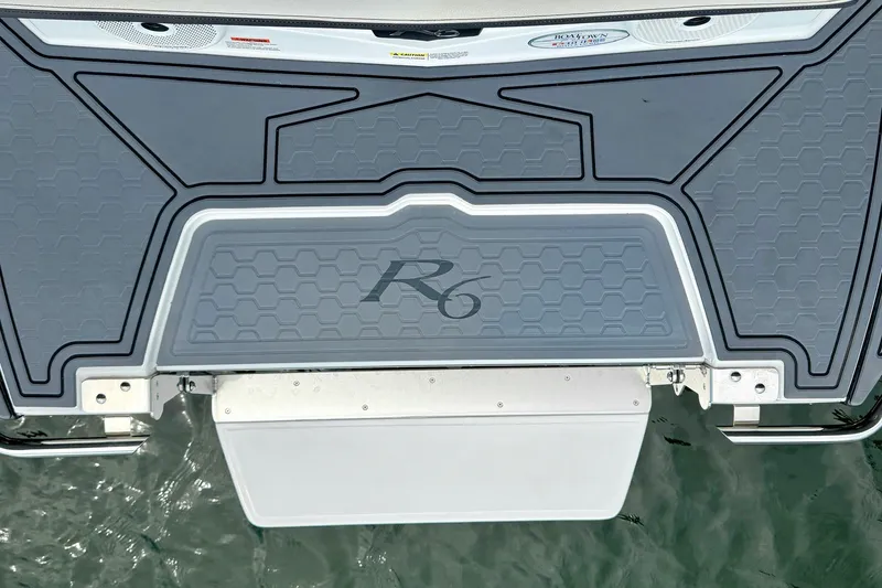 Slide: The Image of 2023 Cobalt R6 Surf boat swim platform with textured gray surface. - 44