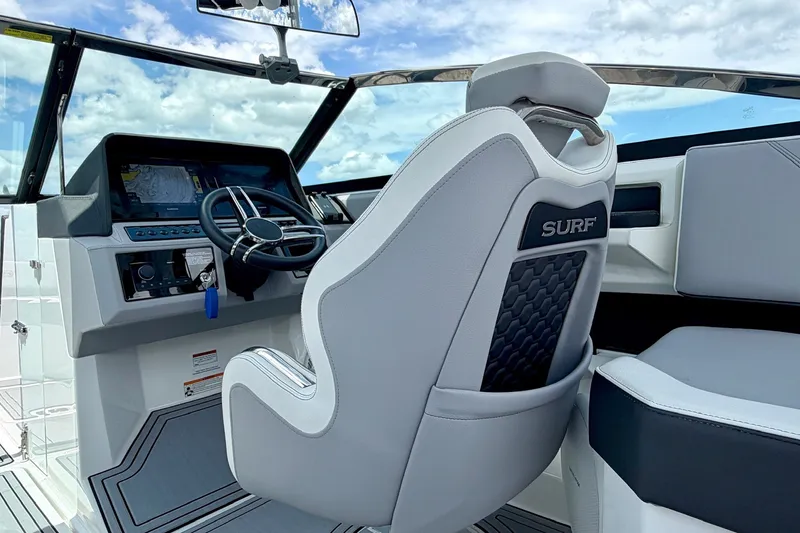 Slide: The Image of 2023 Cobalt R6 Surf boat interior with steering wheel and captain's seat. - 19