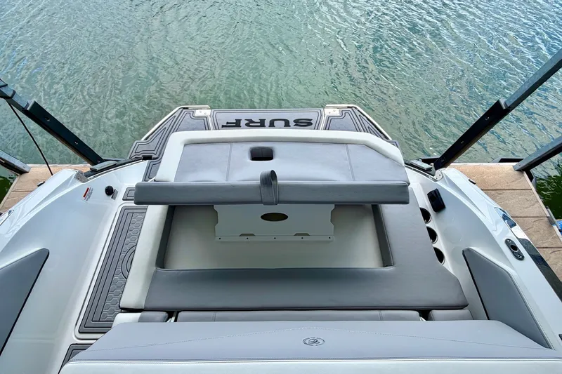 Slide: The Image of 2023 Cobalt R6 Surf boat with sleek seating and swim platform by the water. - 45