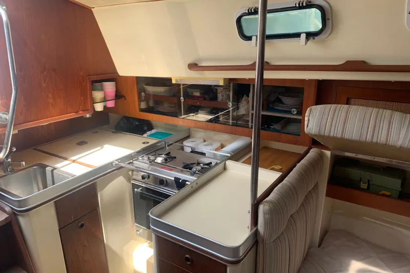 Slide: The Image of Interior of 1984 CS Sailcraft yacht kitchen with stove, sink, and storage cabinets. - 5