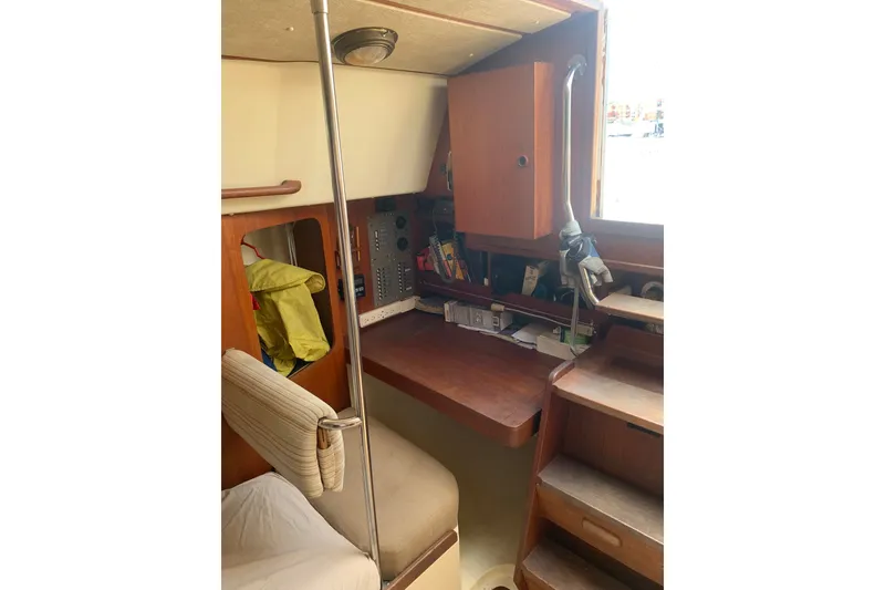 Slide: The Image of 1984 CS Sailcraft interior with wooden desk, storage, and nautical equipment. - 7