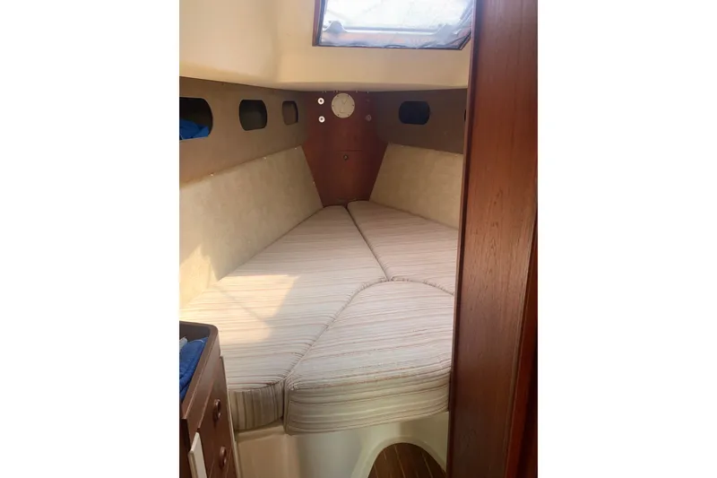 Slide: The Image of Cozy cabin interior of 1984 CS Sailcraft, featuring a comfortable V-berth and wooden accents. - 8