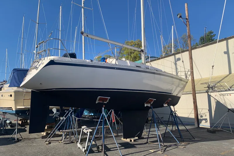 Slide: The Image of 1984 CS Sailcraft sailboat on stands in a marina, clear blue sky background. - 9