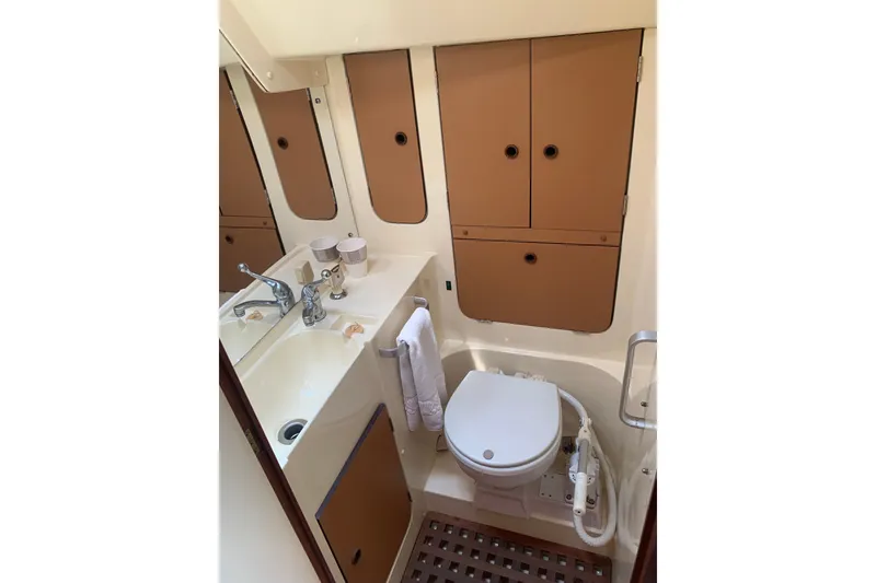 Slide: The Image of Compact 1984 CS Sailcraft bathroom with sink, toilet, and storage cabinets. - 6