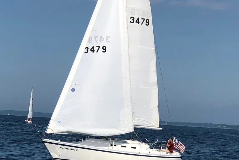 Slide: The Image of Sailboat "Moonshadow" on open water, CS Sailcraft 1984, with American flag. - 3