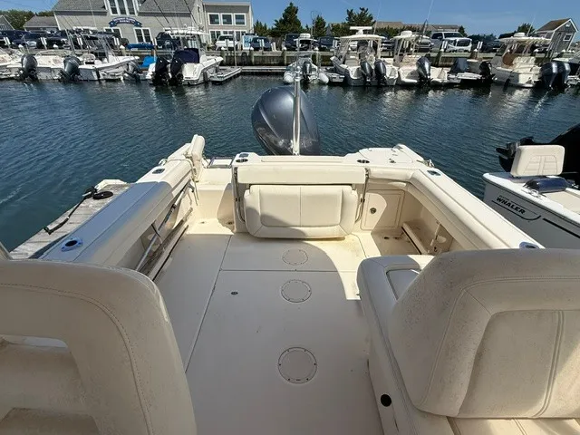 Slide: The Image of The image shows the cockpit of a 2015 Grady-White Freedom 255 boat docked in a marina. - 9