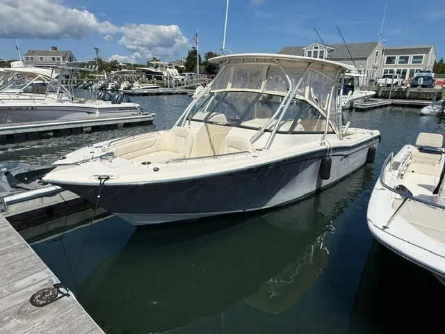 The Image of A 2015 Grady-White Freedom 255 boat docked at a marina, surrounded by other boats. - 0