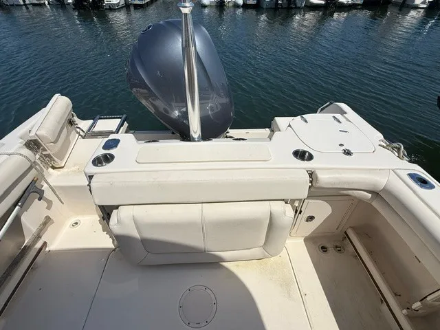 Slide: The Image of The image shows the stern of a 2015 Grady-White Freedom 255 boat on the water. - 12
