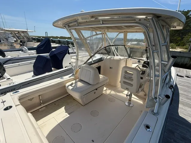 Slide: The Image of A 2015 Grady-White Freedom 255 boat with an open cockpit and helm station. - 6