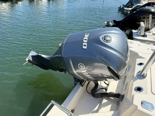 Slide: The Image of A Yamaha outboard motor is mounted on the stern of a boat floating in the water. - 5