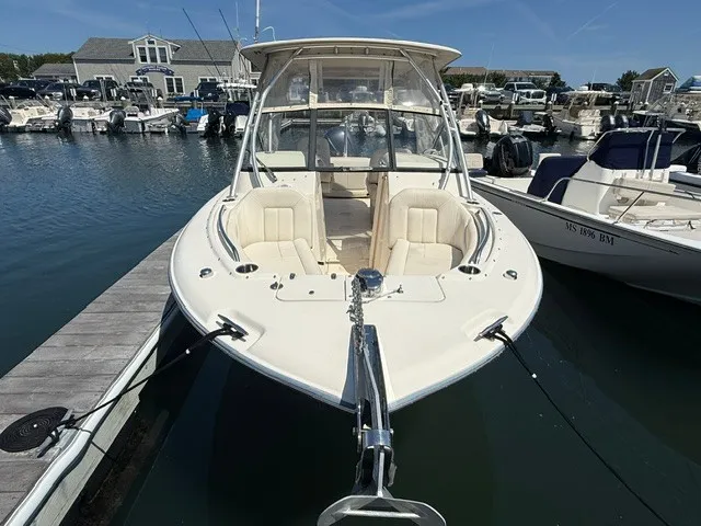 Slide: The Image of A 2015 Grady-White Freedom 255 boat docked in a busy marina. - 1