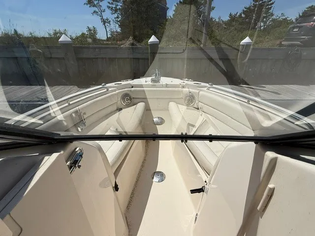 Slide: The Image of The image shows the cockpit of a 2015 Grady-White Freedom 255 boat with beige seating. - 14